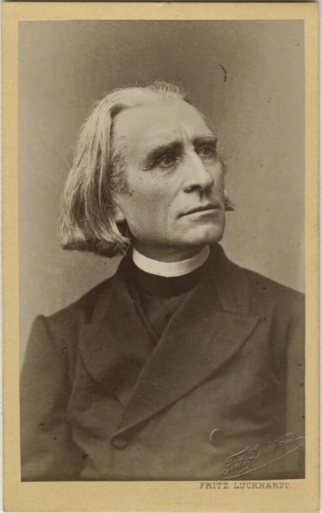 Franz Liszt portrait by Fritz Luckhardt in 1871. Liszt wears his abbe cloth. His hair is short. He does not look at the camera.