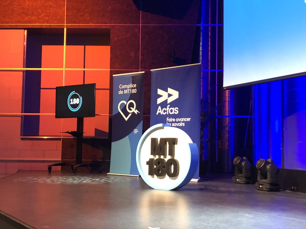 Chronomètre indiquant 180 secondes, logo MT180 et poster de l'Acfas / Chronometer showing 180 seconds, logo MT180 and poster de l'Acfas