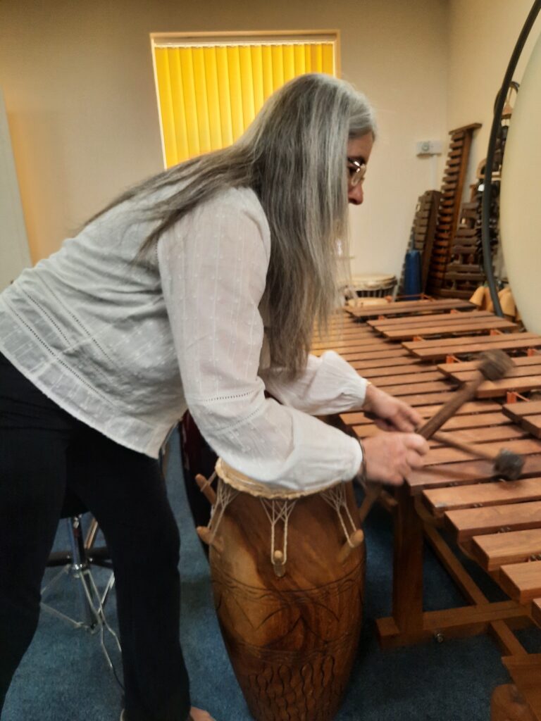 Evelyn plays a gigantic marimba.